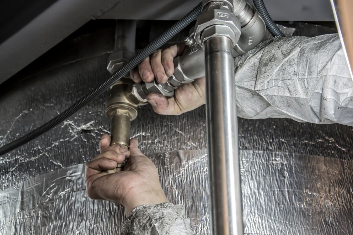 Plumber installing pipes